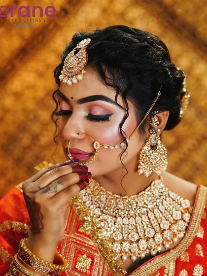 A close-up shot focusing on the detailed eye makeup and the traditional nose ring.