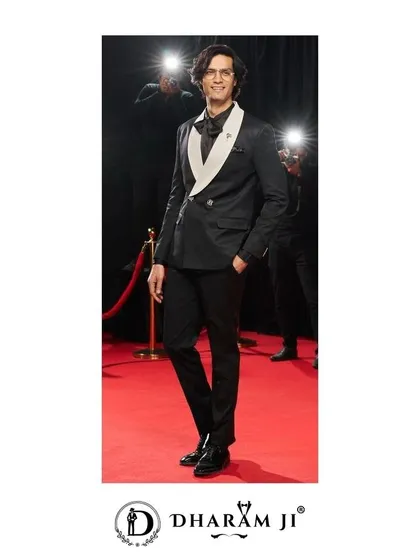 This black double-breasted tuxedo with a contrasting white lapel is a modern classic. It's perfect for a black-tie wedding or a high-fashion event.