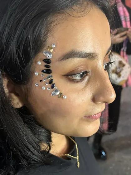 A dramatic crescent moon design made with black, silver, and pearl gems. This is a very popular look for festivals and parties.