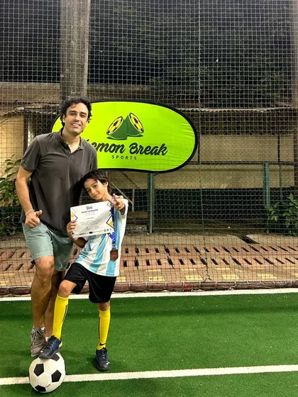 Posing with his medal and certificate, this young player is on the right path. We are proud to be a part of his football journey.