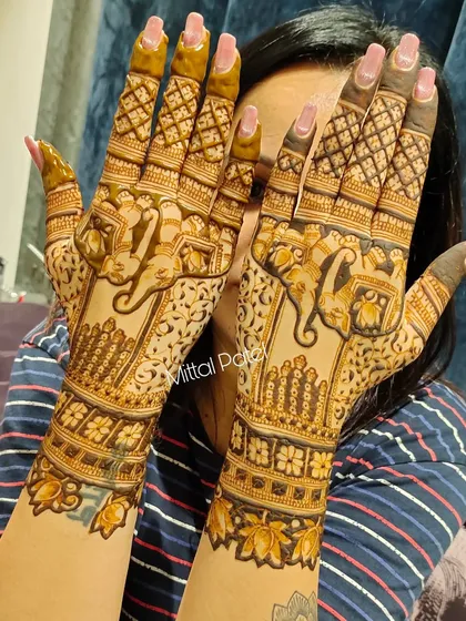 A client playfully showing off her heavy back-hand design 인기 elephant motifs.