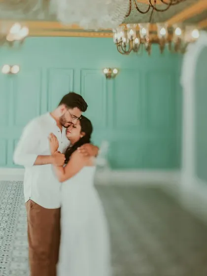 A dreamy, soft-focus shot of a couple in an elegant room, creating an ethereal and romantic mood. This artistic technique is perfect for capturing a fairytale-like pre-wedding portrait.