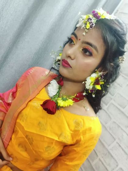 A closer look at the Haldi makeup created by one of our beauty culture students. Notice the bright, blended eyeshadow in yellow and orange tones, perfectly matching the festive theme, and the delicate fresh flower jewelry.