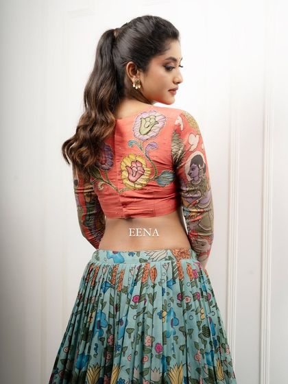 Discover the beauty of traditional craftsmanship with this stunning Pen Kalamkari lehenga. The piece is meticulously hand-painted by my artisans, with a story unfolding on the blouse sleeves and a beautiful floral pattern on the skirt and dupatta.