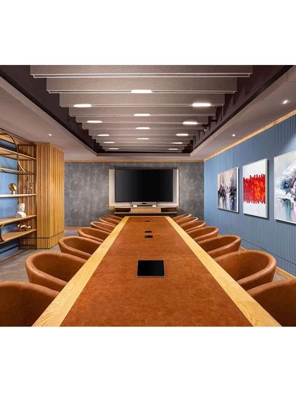 The main conference room at Paras Healthcare is a sophisticated space with a bold blue accent wall and a leather-topped table. The design balances formal requirements with a comfortable, inspiring atmosphere.