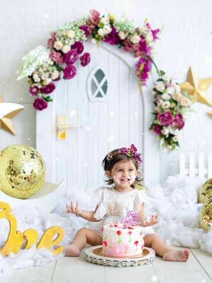 A fairy-themed cake smash for a magical first birthday. Even with a bit of frosting on her face, this little one looks absolutely enchanting among the stars and clouds.