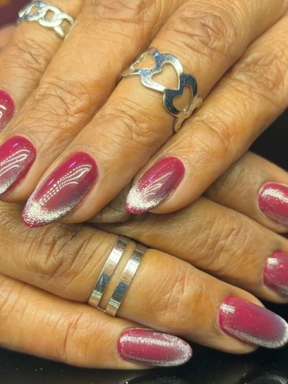 A side view of the red and silver glitter ombre, showing the gradient effect on almond nails.