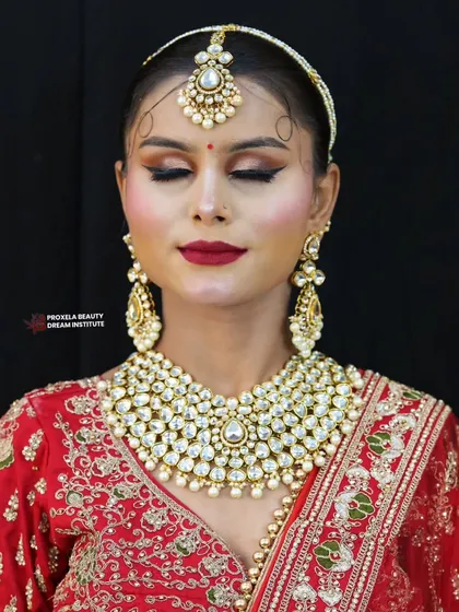 The beauty is in the details. This close-up shows the delicate shimmer on the eyelids and the classic winged liner, paired with a timeless red lip.