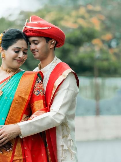 A classic and elegant pose from a Maharashtrian pre-wedding shoot. The couple's embrace and the rich colors of their traditional outfits create a timeless portrait.