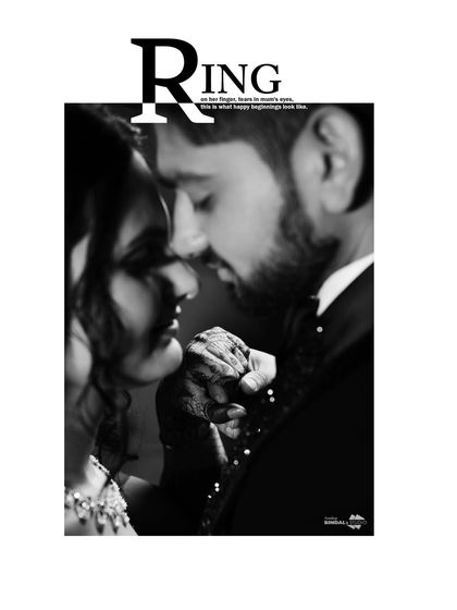 A powerful black and white close-up, focusing on the couple's hands and faces. The "RING" text overlay makes this a stylish and modern engagement announcement photo.