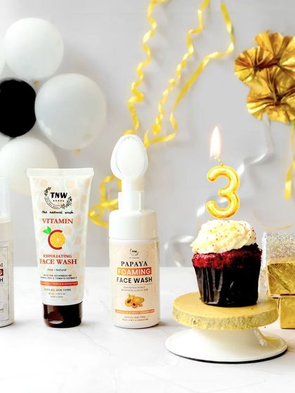 Another angle from the brand's third birthday campaign. This shot captures the celebratory mood with gold streamers, a cupcake, and a selection of their popular foaming face washes.