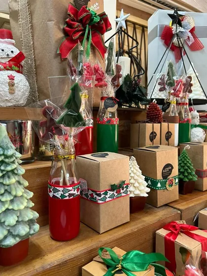 A closer look at my market stall, showing the Christmas tree candles, snowman, and candle stick sets.