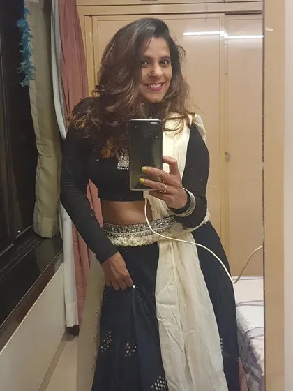 A mirror selfie capturing my Navratri look. It's all about the details, from the outfit to the accessories, to feel ready to dance the night away.