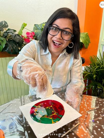 The look of pure joy and excitement while creating. This participant is having a blast pouring colors at our Women's Day fluid art event.