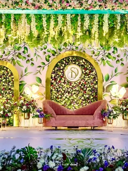 This engagement stage blends natural and modern elements. We used a painted leaf-motif backdrop, three-dimensional floral arches, and a custom monogram to create a personalized and artistic setting.