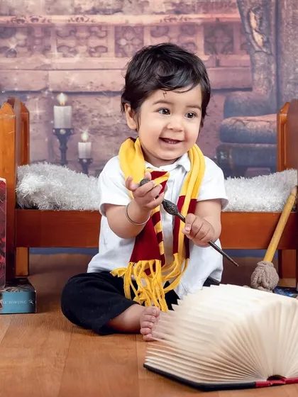 This little wizard is ready to cast a spell of cuteness. The full setup with books and props makes for an immersive Harry Potter experience.