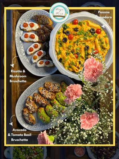 An example of our Italian gifting platters. This spread includes Penne Pomodoro and two types of bruschetta: Ricotta & Mushroom and Avocado & Tomato Basil, decorated with fresh flowers.