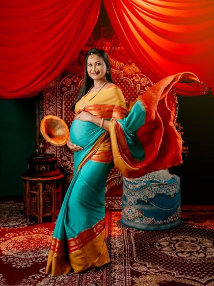 Capturing the flow and elegance of a traditional saree. The vibrant turquoise and yellow fabric creates beautiful movement against a rich, warm-toned backdrop.