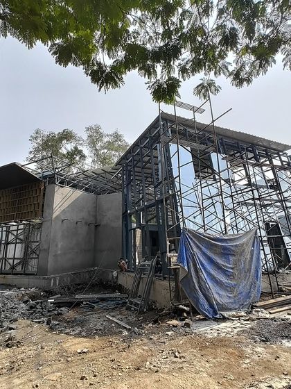 The steel and glass skeleton of the 22,000 sq ft Experience Center in Mumbai under construction. This image shows the building's core structure before the final facade is applied.