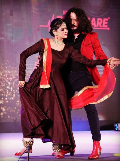 A pose that captures the distinct yet complementary aesthetics of Flamenco and Kathak. This fusion is a visual treat, perfect for sangeets and celebratory events.