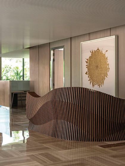 A striking parametric reception table designed for the directors' floor of 'The Layered Office'. The fluid, sculptural form of the desk serves as a piece of functional art in the main circulation space.