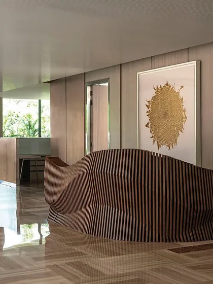 A striking parametric reception table designed for the directors' floor of 'The Layered Office'. The fluid, sculptural form of the desk serves as a piece of functional art in the main circulation space.