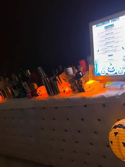 Our spooky Halloween party setup, featuring pumpkin lights and our LED bar menu. We go all-out on themed parties to create an immersive experience.