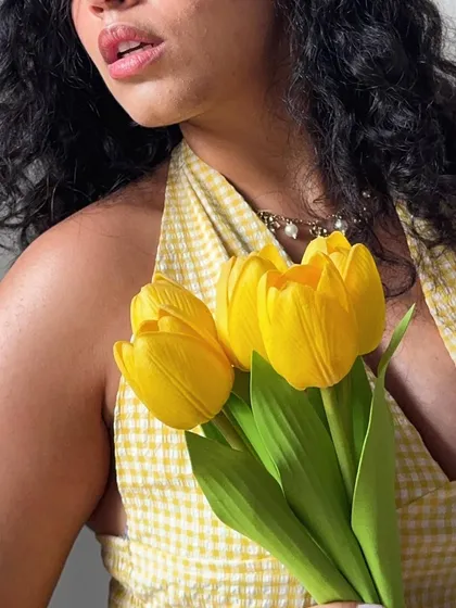 A cropped shot focusing on the flowers and the neckline of my top. This highlights the color coordination and texture of the outfit.