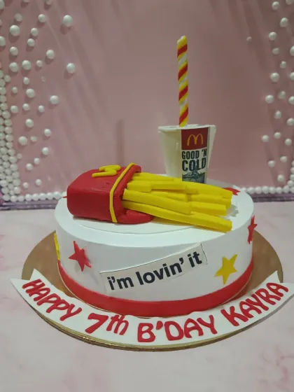 A fun cake for someone who's "lovin' it." This McDonald's-themed cake features fondant fries and a drink cup.