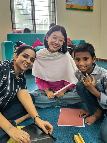 A group of volunteers and children work together on a friendship day craft. These sessions are about more than just stories; they are about building a supportive and caring community.