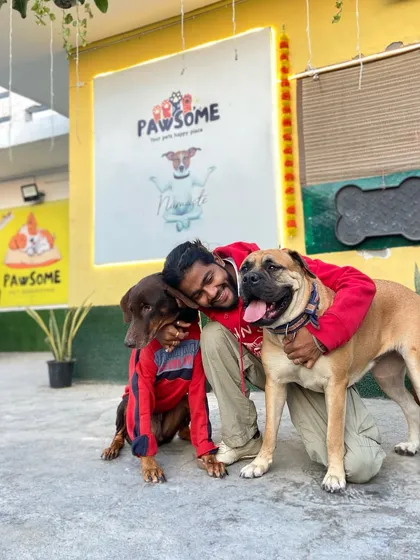 No two barks are alike, but every dog speaks the universal language of love. Here I am sharing a moment with a Doberman and a Bullmastiff.