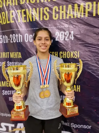 Ananya Chande proudly displaying her two winner's trophies from the 5-Star District Ranking Tournament. She was crowned champion in both the U-19 and Women's categories.