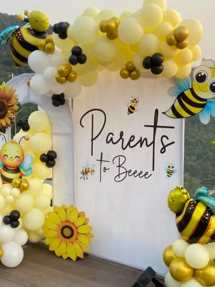 The complete bee-themed backdrop, with balloon garlands, bee cutouts, and sunflowers, ready for the baby shower celebration to begin.