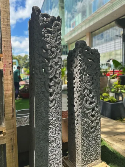 Frame your space with timeless elegance. These tall, hand-carved stone pillars feature intricate traditional Balinese patterns, perfect for adding architectural drama to an entryway, garden path, or patio.