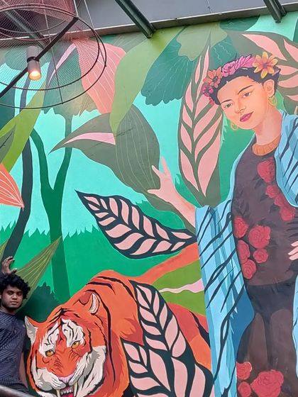 Another angle of the Frida mural, highlighting the details in her expression and the surrounding tropical leaves. Every element is hand-painted to contribute to the overall powerful and colorful effect.