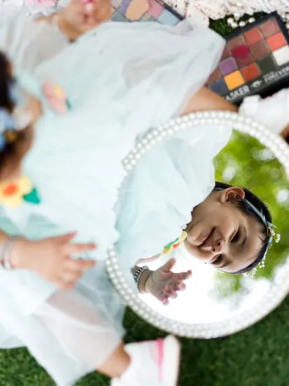 An overhead view of our little model and her reflection. This perspective captures the whole setup and her adorable expression.