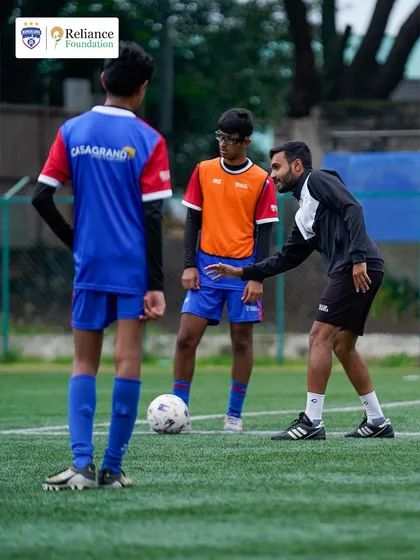 Our certified coaches provide personalized guidance to every player. Here, a coach offers tactical advice during a training drill, focusing on positioning and game awareness to help our young athletes think like pros.