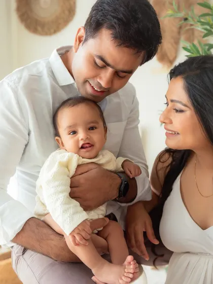 A perfect family moment, filled with smiles and warmth. This 6-month milestone session shows how I incorporate parents to create natural, loving portraits of the whole family together.