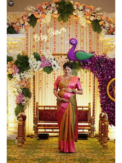 A solo portrait of the mother-to-be during her traditional baby shower. I focus on capturing the details of the event, from the floral decorations and swing to the traditional attire, preserving the memory of the celebration.