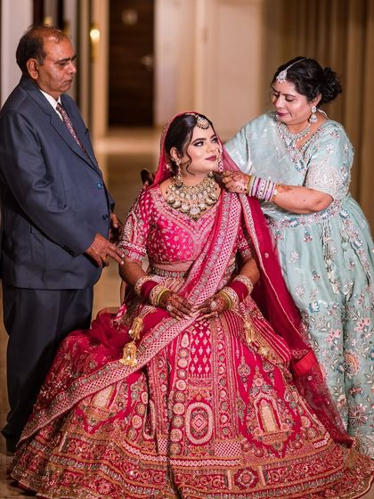 A precious moment between the bride and her parents. It's an honor to be part of these memories, ensuring the bride looks and feels her absolute best as she is surrounded by her loved ones.