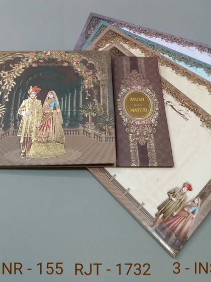 This invitation set features a royal couple in a grand palace hall, with a separate band holding the inserts. The rich brown and gold tones give it a warm and luxurious feel.