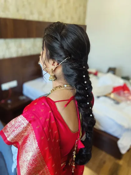 A side angle capturing the intricate weaving of the braid and the delicate accessories.