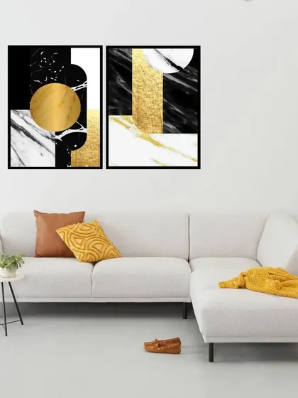 This set of two framed prints features a rakish abstract design in black, white, and gold. The combination of marble texture and metallic accents creates a luxurious and modern art piece.