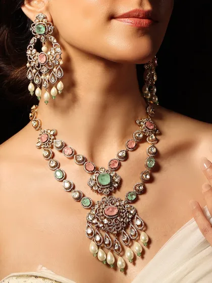 A delicate pastel dream. This layered necklace set combines soft pink and green stones with polki and pearls, creating a romantic and elegant look perfect for a daytime wedding.