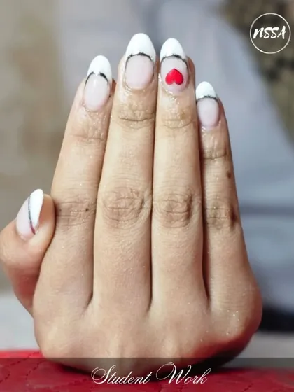 A modern take on the French manicure with a heart accent, showcasing our student's ability to create clean lines and minimalist designs.