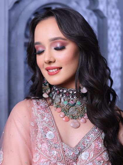 A close-up of the dramatic eye makeup. The blend of pink and black creates a look that is both romantic and edgy.