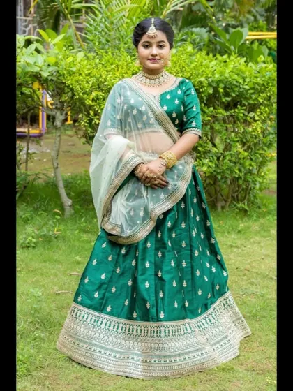 This emerald green silk lehenga is a classic choice for any wedding function. The rich green fabric is adorned with small silver motifs and a heavy, intricate border.