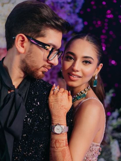 A romantic couple portrait from the reception. The bride's makeup is dreamy and ethereal, matching the floral fantasy decor.
