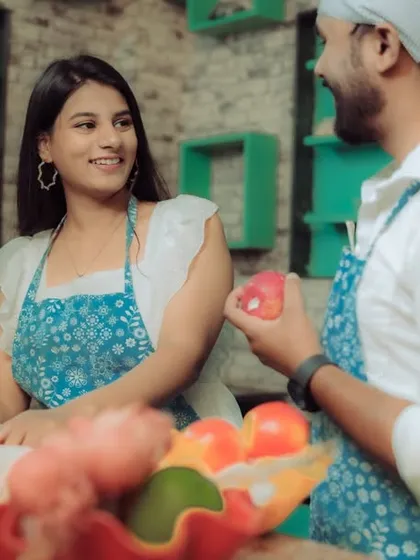 Love is cooking up something beautiful! This couple shares a laugh in a quirky kitchen setting, a perfect example of a themed pre-wedding shoot that reflects shared interests and creates fun, natural interactions.