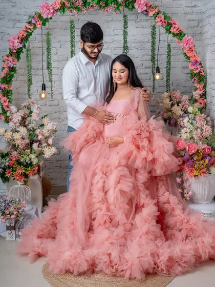 A sweet couple's pose in our romantic floral arch setup. The partner's gentle embrace adds a layer of warmth and love.